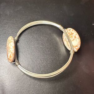 Silver wired metal bracelet with two oval brown swirled stones